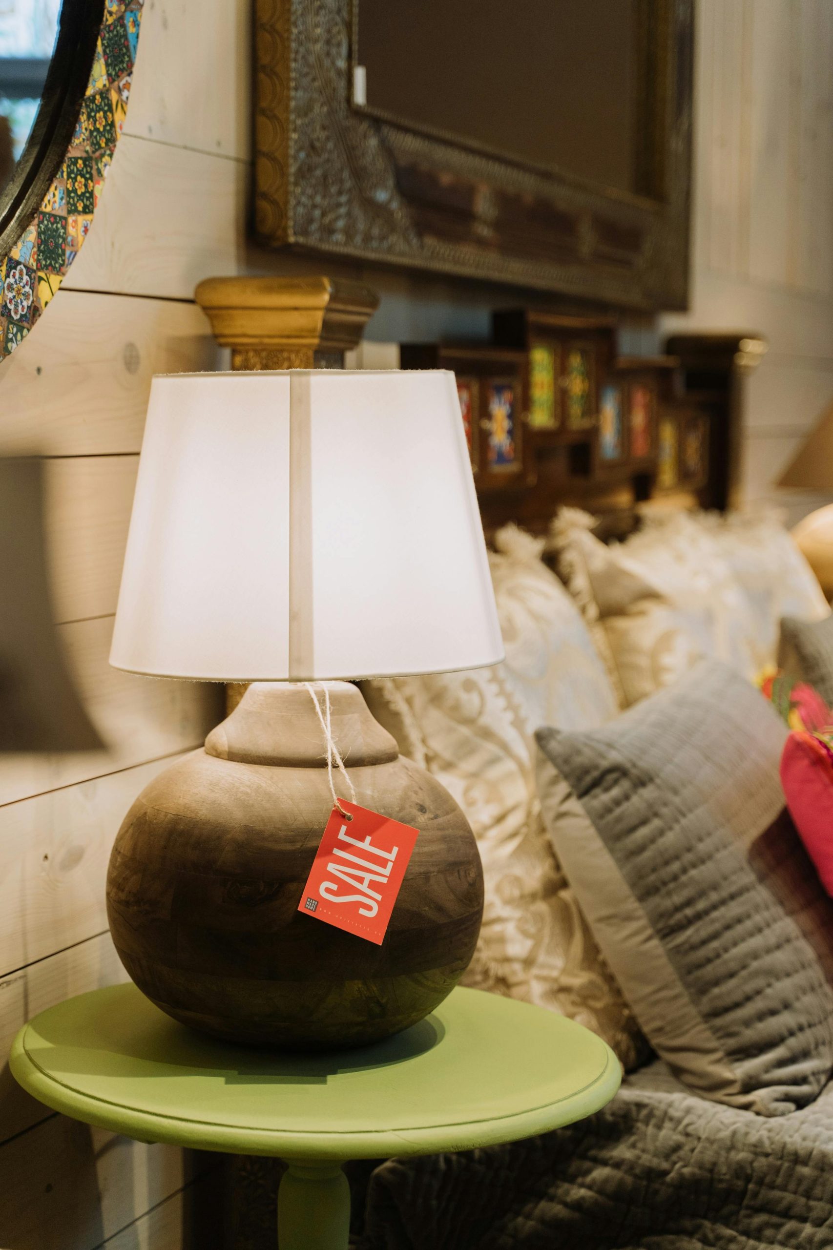 Warm indoor setting featuring a table lamp with a sale tag, perfect for interior decoration.