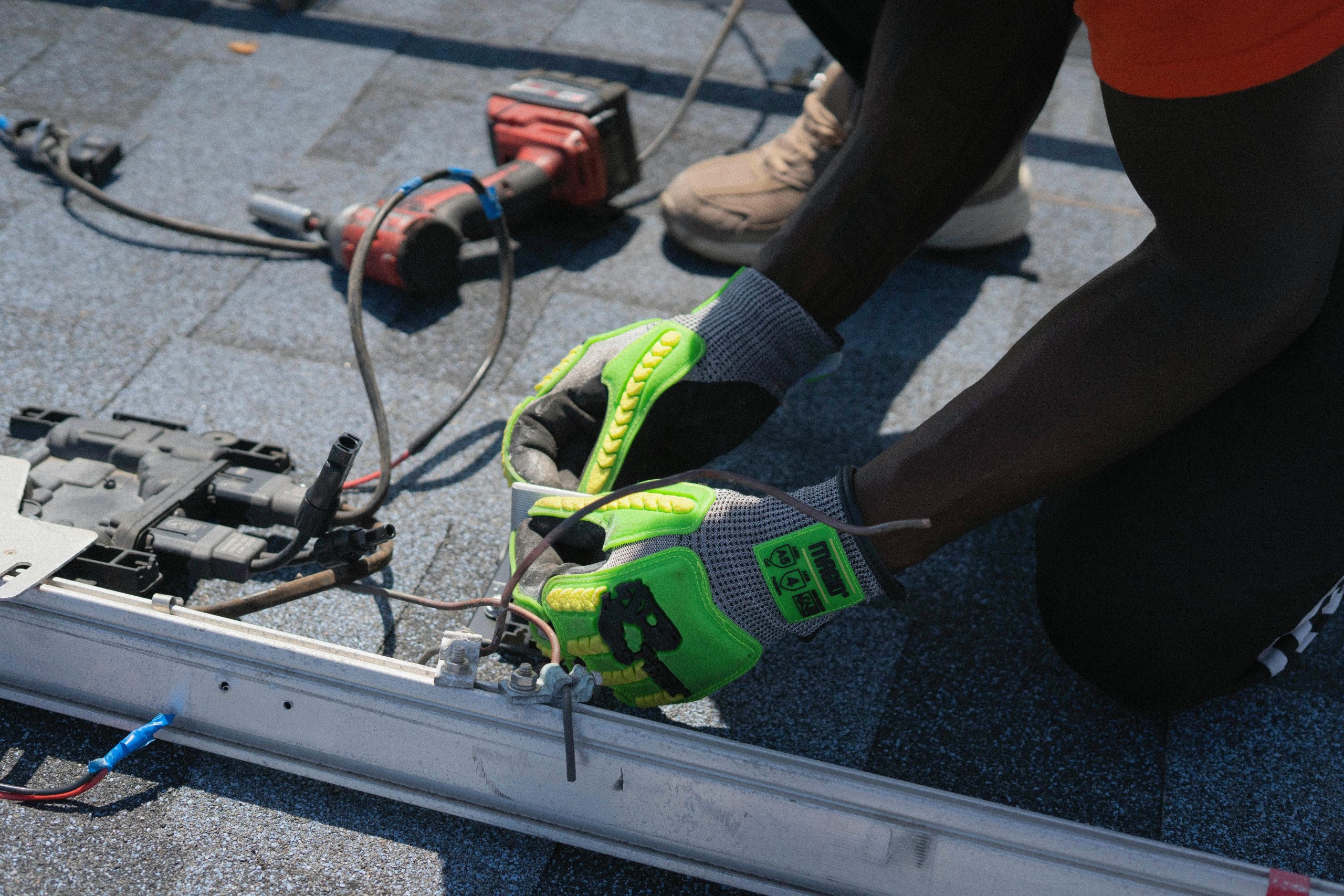 Services Technician installing solar panels on a roof in Tampa, showcasing clean energy efforts.